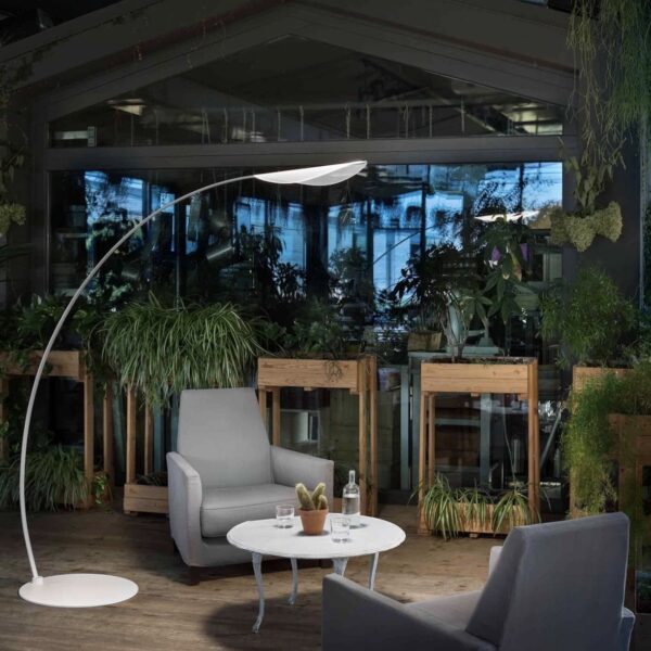 Stilnovo vloerlamp diphy lampenkap model 8165 wit licht in een ruimte met stoel en tafel